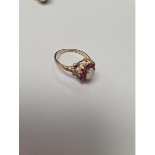 1040 - Pretty 9ct ruby and opal cluster ring with central oval opal surrounded rubies, marked 375, size O, ... 