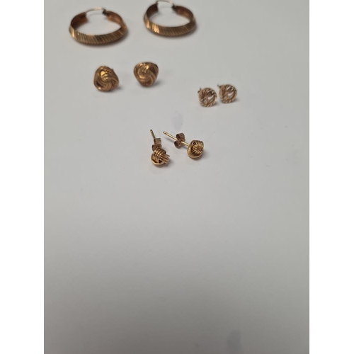 1057 - Pair of 9ct yellow gold hoops, 2 pairs of 9ct knot design ear studs and pair of 'St Christopher' ear... 