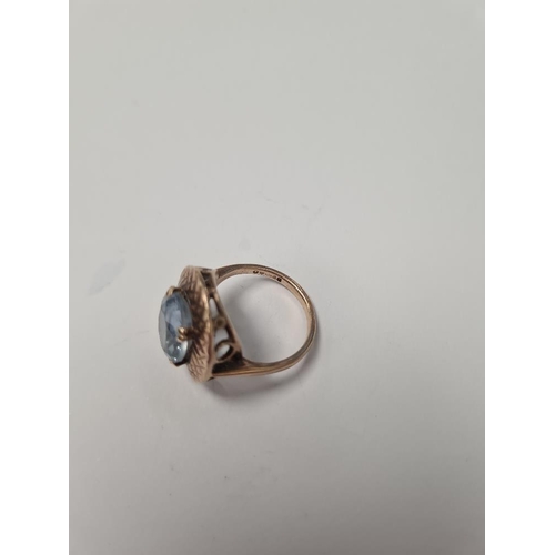 1074 - 9ct rose gold dress ring with oval blue paste surrounded by gold etched frame, size N, marked 375, a... 