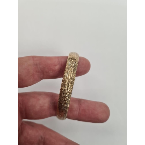 1132 - 9ct yellow gold bangle with allover etched decoration, AF, misshapen, 6.5cm diameter, marked 375, ap... 