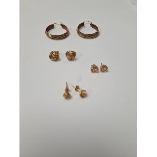 1057 - Pair of 9ct yellow gold hoops, 2 pairs of 9ct knot design ear studs and pair of 'St Christopher' ear... 