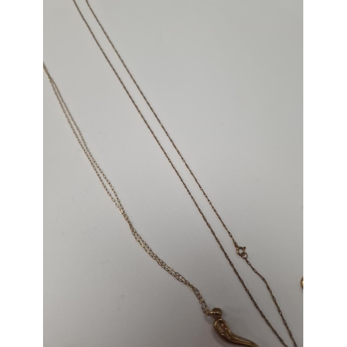 1059 - Fine 9ct yellow gold chains, one hung with a pendant, and another 9ct gold pendant set with blue top... 