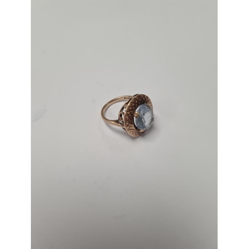 1074 - 9ct rose gold dress ring with oval blue paste surrounded by gold etched frame, size N, marked 375, a... 