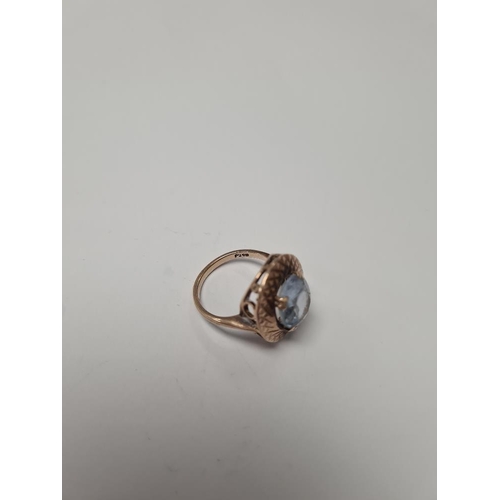 1074 - 9ct rose gold dress ring with oval blue paste surrounded by gold etched frame, size N, marked 375, a... 