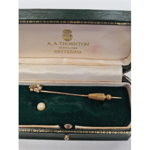 1126 - Unmarked yellow gold stick pin, with pearl and diamond detail to head, unmarked, in fitted case, app... 