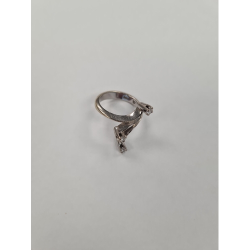 1164 - Contemporary 14K white gold dress ring of crossover design each spoke with a brilliant cut diamond, ... 