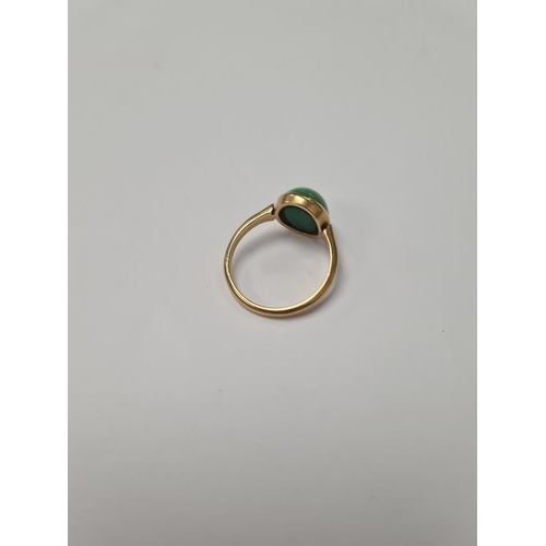 1025 - 18ct yellow gold dress ring, with large cabouchon green hardstone, size Q, marked 18ct, 4.16g approx