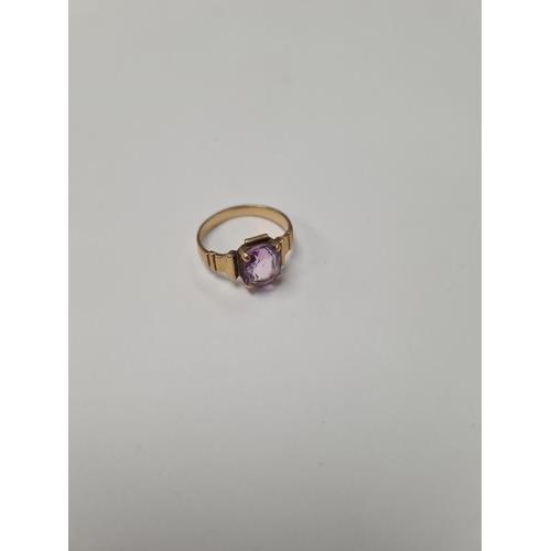 1026 - Unmarked yellow gold, possibly 18ct dress ring with 4 claw mounted mixed cut amethyst on stepped sho... 