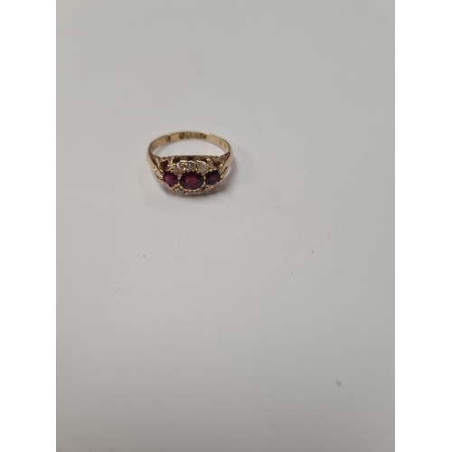 1029 - 18ct yellow gold ring with 3 round cut rubies in diamond chip inset frame, marked 18, Birmingham, si... 