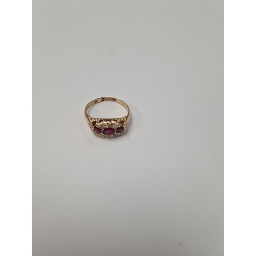 1029 - 18ct yellow gold ring with 3 round cut rubies in diamond chip inset frame, marked 18, Birmingham, si... 