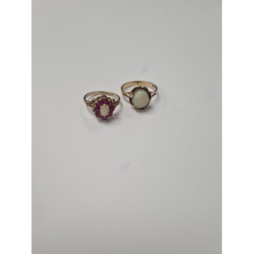 1040 - Pretty 9ct ruby and opal cluster ring with central oval opal surrounded rubies, marked 375, size O, ... 