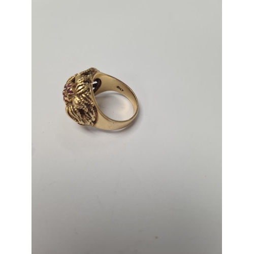 1073 - 18K yellow gold dress ring of decorative form, two flower heads, one inset rubies the other sapphire... 