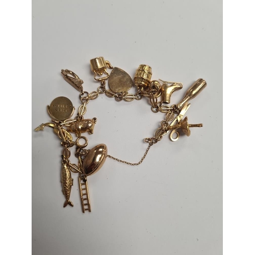 1096 - 9ct gold fancy link bracelet hung with 15 9ct gold charms to incl, ballerina, harp, pig, salmon, gon... 