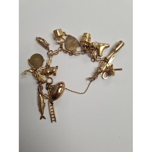 1096 - 9ct gold fancy link bracelet hung with 15 9ct gold charms to incl, ballerina, harp, pig, salmon, gon... 