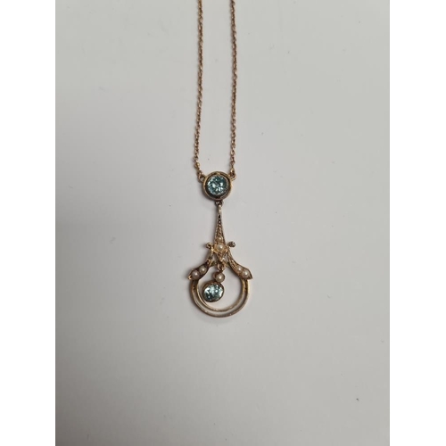 1099 - Pretty Edwardian necklace with fine neck chain leading to pendant with rubover set aquamarine above ... 