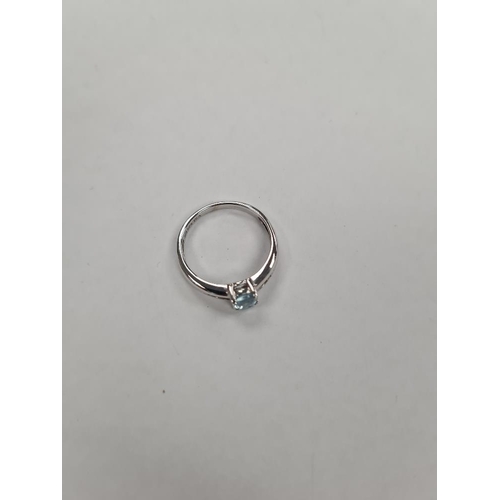 1134 - Contemporary 9ct white gold dress ring central oval blue topaz, the shoulders inset graduating diamo... 