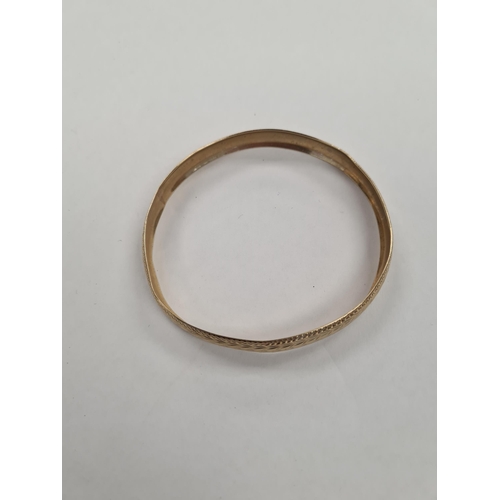 1132 - 9ct yellow gold bangle with allover etched decoration, AF, misshapen, 6.5cm diameter, marked 375, ap... 