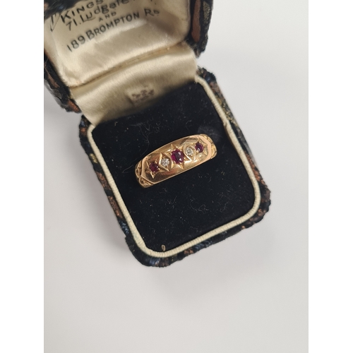 1012A - 18ct yellow gold ruby and diamond band ring, all starburst set, marked 18, Birmingham, size M, 3g.