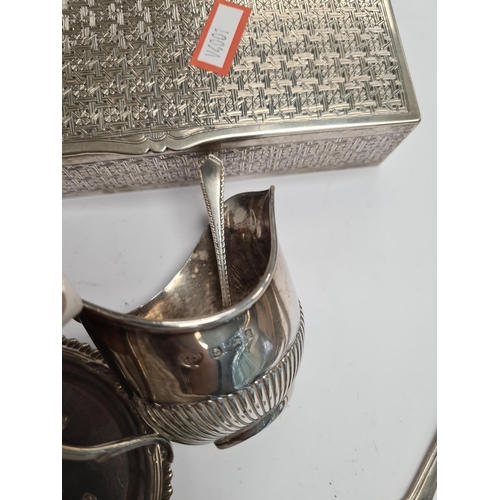 12 - A white metal decorative rectangular box, silver trinket dish, napkin rings, bangle, sauce boat by S... 