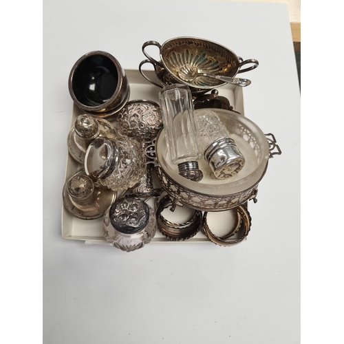 17 - A quantity of silver items to include a set of napkin rings, silver topped cut glass bottles, mustar... 
