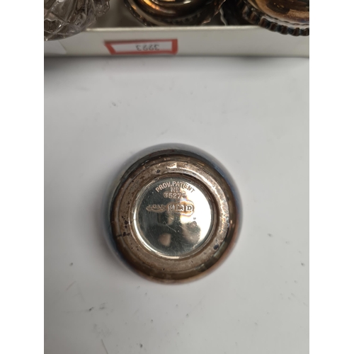 17 - A quantity of silver items to include a set of napkin rings, silver topped cut glass bottles, mustar... 
