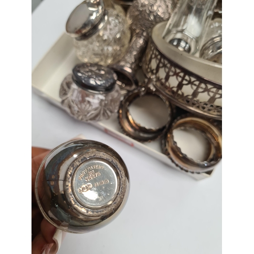17 - A quantity of silver items to include a set of napkin rings, silver topped cut glass bottles, mustar... 
