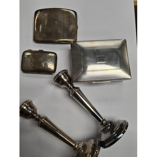 18 - A quantity of silver weighted candlesticks having beaded raised pedestal circular foot. Hallmarked B... 