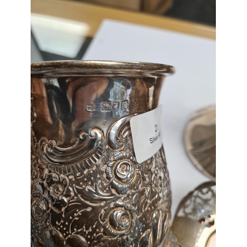 21 - A superb silver Edwardian tankard having heavily embossed bulbous body on a raised circular pedestal... 