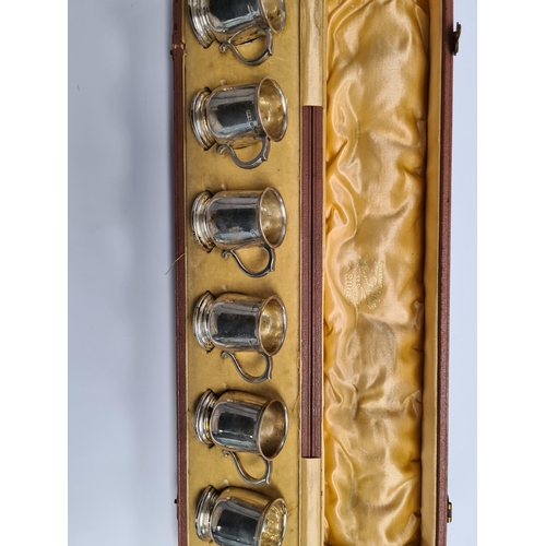 25 - An attractive cased set of six silver top cups in the form of tankards, by E S Barnsley and Co., Bir... 