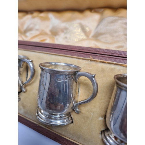 25 - An attractive cased set of six silver top cups in the form of tankards, by E S Barnsley and Co., Bir... 