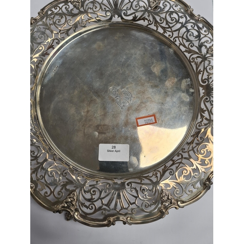 28 - A beautiful Edwardian silver tray of circular form, having pierced decorative border, four scroll fe... 