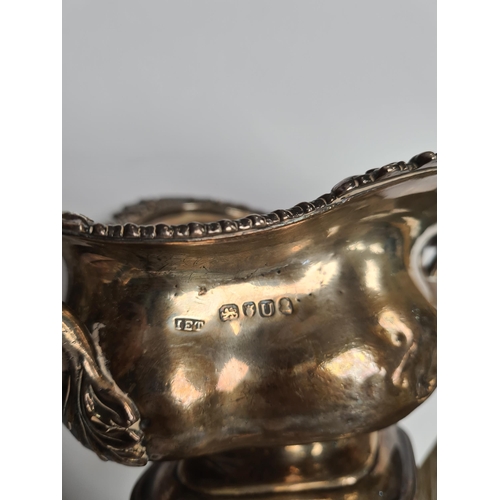 29 - A very heavy silver Georgian bowl, on a pedestal foot, with two handles and gadrooned and foliate em... 