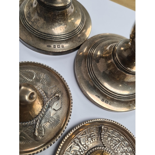 39 - A silver heavily embossed back mirror. Hallmarked Birmingham 1912, W J Myatt and Co. A pair of minia... 