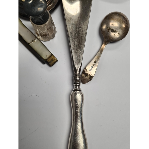 39 - A silver heavily embossed back mirror. Hallmarked Birmingham 1912, W J Myatt and Co. A pair of minia... 