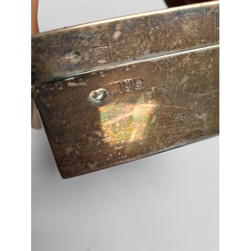 41 - A silver cigarette box by Goldsmiths and Silver Smiths Co Ltd., London 1913. Condition Report: Lid d... 