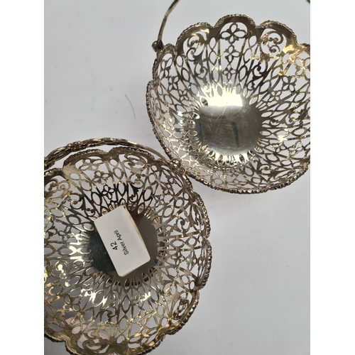 42 - A pair of very ornate silver bon bon dishes with pierced handle and pretty floreated pierced body. B... 