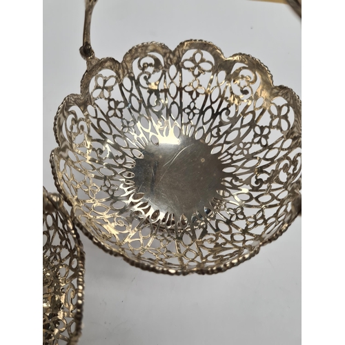 42 - A pair of very ornate silver bon bon dishes with pierced handle and pretty floreated pierced body. B... 