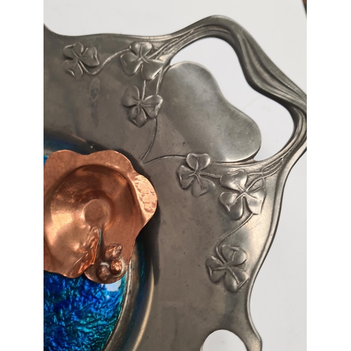 49 - Liberty and Co. A Tudric pewter bowl by Liberty and Co., having enamel roundel. Decorative clover de... 