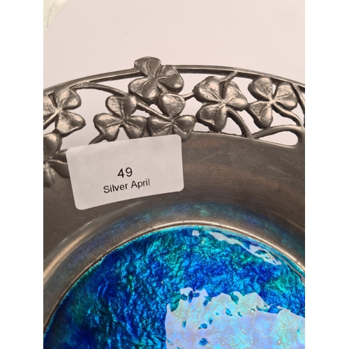 49 - Liberty and Co. A Tudric pewter bowl by Liberty and Co., having enamel roundel. Decorative clover de... 