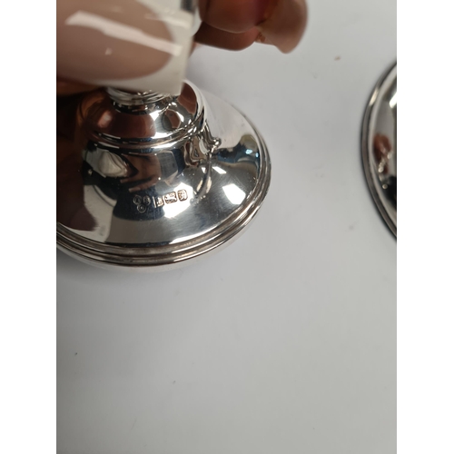 56 - A silver candlestick by Wai Kee, and a miniature candlestick by ESC, 21.5cm approx and 7.5cm approx ... 