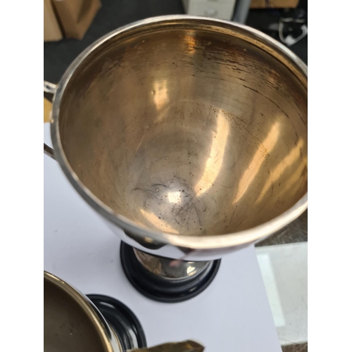 8 - A silver trophy cup by Fred H Adams and Co., Birmingham 1913. Two handles on vacant body, on a stand... 