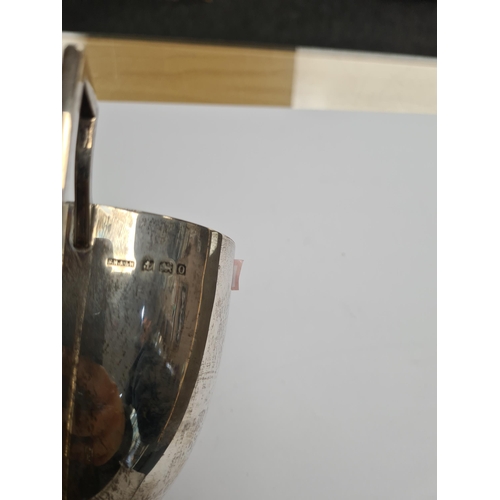 8 - A silver trophy cup by Fred H Adams and Co., Birmingham 1913. Two handles on vacant body, on a stand... 