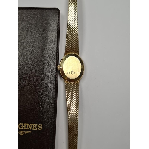 1102 - Longines; A 14K yellow gold ladies cocktail watch with oval golden dial, and baton markers, marked 5... 