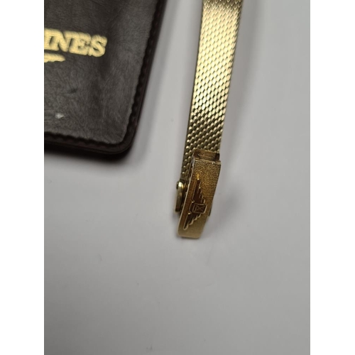 1102 - Longines; A 14K yellow gold ladies cocktail watch with oval golden dial, and baton markers, marked 5... 