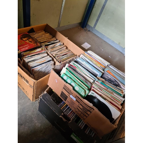 59 - Quantity of 7 inch vinyl singles in two boxes and one other tray of CDs