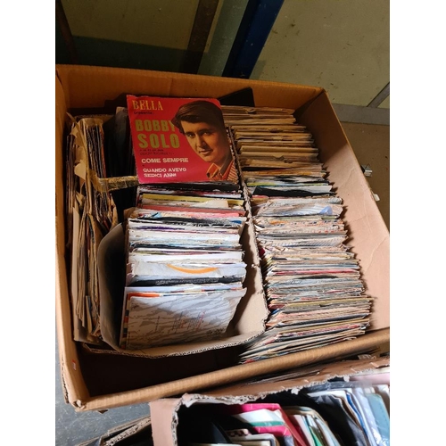 59 - Quantity of 7 inch vinyl singles in two boxes and one other tray of CDs