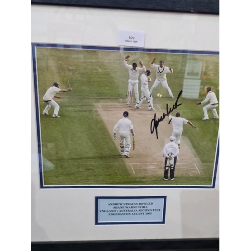A signed photograph of Andrew Strauss bowling Shane Warne in second test, 2005