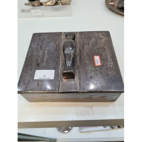 An attractive silver table cigar box having two compartments and silver handles.  Hallmarked London 1901, Wright and Davies.  Approx 19.5cm x 16.5cm.  Condition report: engraved top
