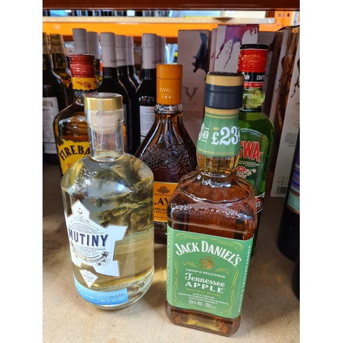 Five bottles of flavoured liquor including Portsmouth Distillery Coconut rum, Jack Daniels Apple, etc.