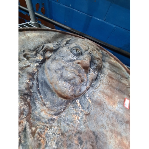 A cast iron circular wall plaque of Benjamin Franklin, 55cm.